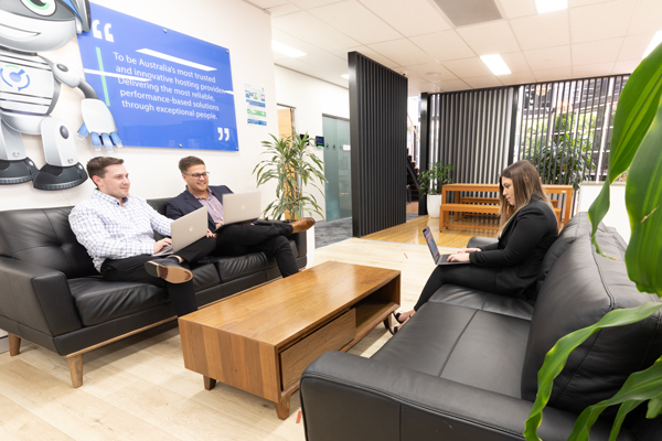 Sales staff sitting on a lounge with laptops